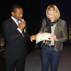 Mr Anthony-Claret Onwutalobi receiving an award from Dr Annika Forsander